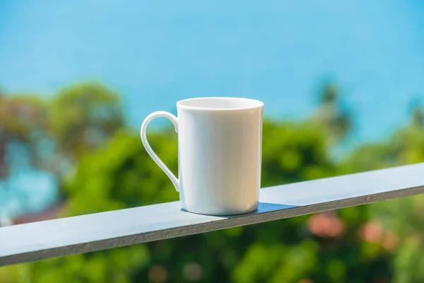 White coffee cup with sea view