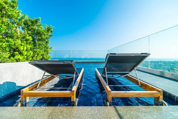 Chair and bed around swimming pool in hotel — Stock Photo, Image