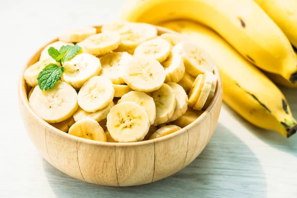 Rohe gelbe Bananenscheiben in Holzschüssel — Stockfoto