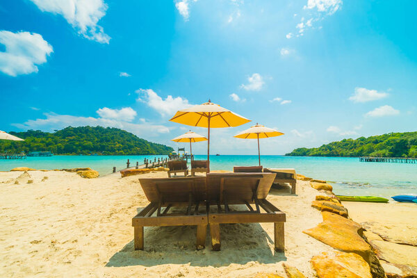 Beautiful tropical beach and sea with coconut palm tree in parad