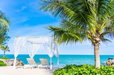 Mavi sk ile plaj denizi okyanusu etrafında güzel şemsiye ve sandalye