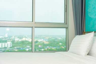 Yastık ve battaniye yatağın üzerinde, içinde lamba süslemesi var.