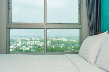 Yastık ve battaniye yatağın üzerinde, içinde lamba süslemesi var.