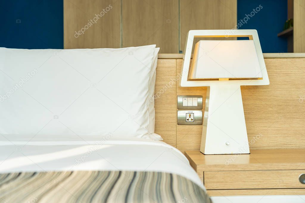 Pillow and blanket on bed with light lamp decoration interior