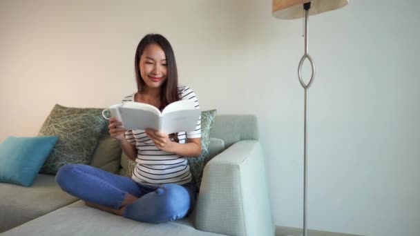 Footage Beautiful Asian Woman Reading Book Drinking Tea Home — Stock Video