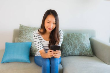 Güzel bir Asyalı kadın portresi. Cep telefonu kullanıyor ya da konuşuyor.