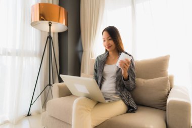 Birlikte bilgisayar ve dizüstü bilgisayar kullanarak güzel bir Asyalı portresi