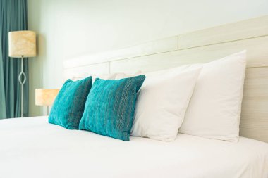 Yastık ve battaniye yatağın üzerinde, içinde lamba süslemesi var.