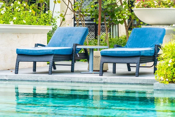 Открытый бассейн в отеле и курорте со стульями — стоковое фото