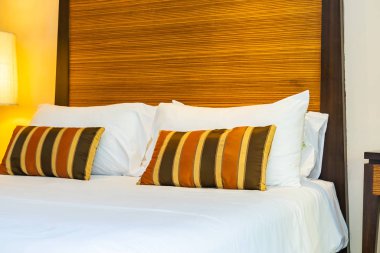 Yatak dekorasyonunda beyaz rahat yastık.