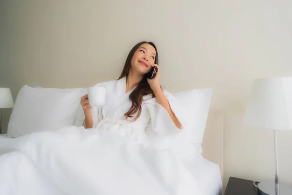 Porträt schöne junge asiatische Frauen mit Kaffeetasse und Handy — Stockfoto