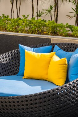 Bahçedeki verandada kanepe ve yastık dekorasyonu var.