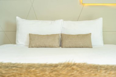 Yatak dekorasyonunda beyaz rahat yastık.