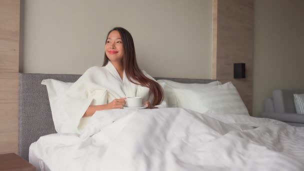 美丽的亚洲女人在家喝一杯热饮放松的镜头 — 图库视频影像