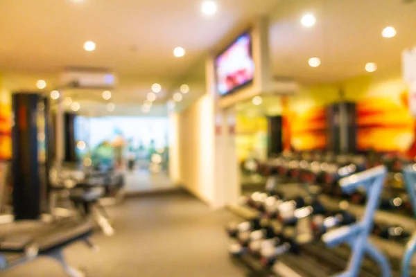 Abstract blur gym room interior with fitness equipment