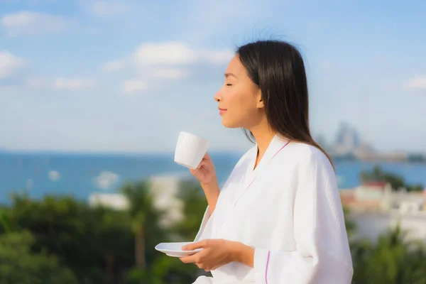 Portrait beautiful young asian women hold coffee cup in hand aro