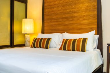 Yatak dekorasyonunda beyaz rahat yastık.