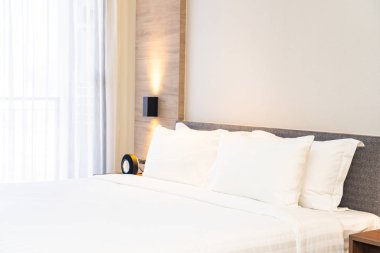 Yatak dekorasyonunda beyaz rahat yastık.