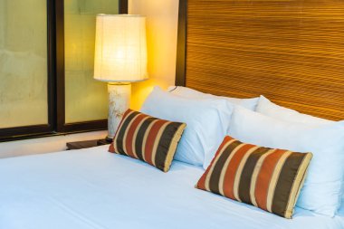 Yatak dekorasyonunda beyaz rahat yastık.