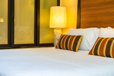 Yatak dekorasyonunda beyaz rahat yastık.