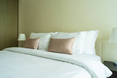 Yatak dekorasyonunda beyaz rahat yastık.