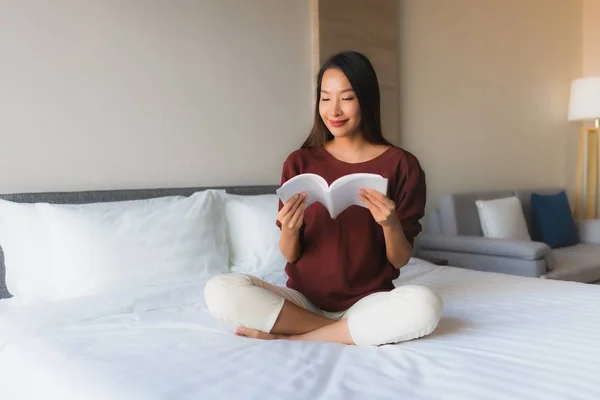 Portrait beautiful young asian women reading book on bed