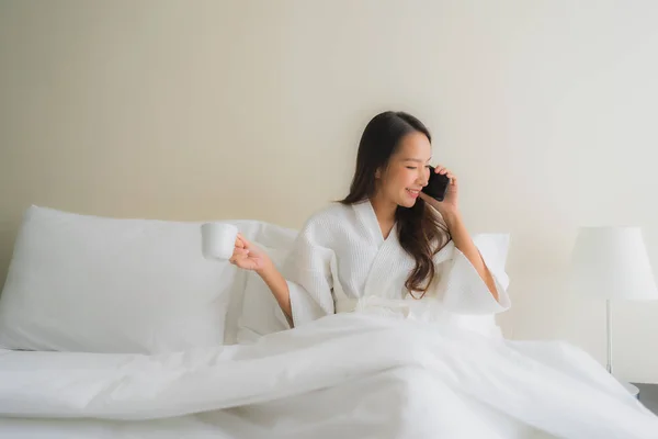 Porträt schöne junge asiatische Frauen mit Kaffeetasse und Handy — Stockfoto