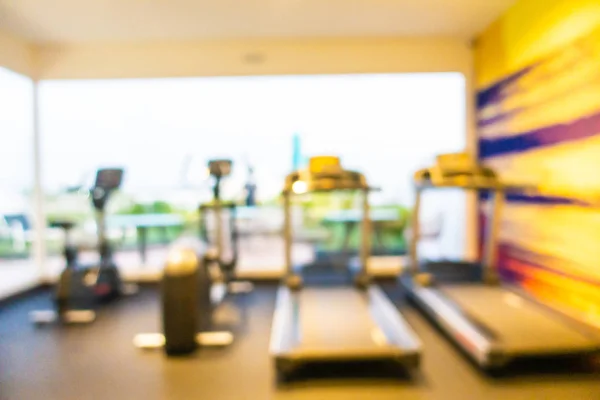 Abstract blur gym room interior with fitness equipment