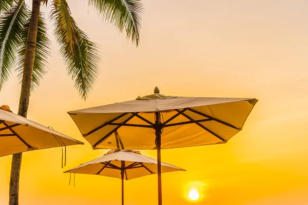 Umbrella and chair on the beautiful beach and sea at sunrise tim — Stock Photo, Image