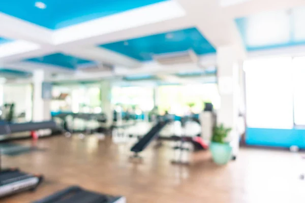 Abstract blur gym room interior with fitness equipment