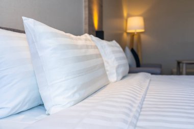 Yatak dekorasyonunda beyaz rahat yastık.