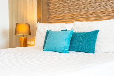 Yatak dekorasyonunda beyaz rahat yastık.