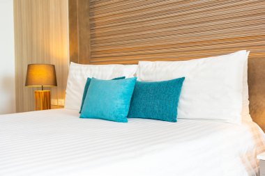 Yatak dekorasyonunda beyaz rahat yastık.