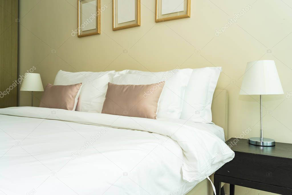 White comfortable pillow on bed decoration interior