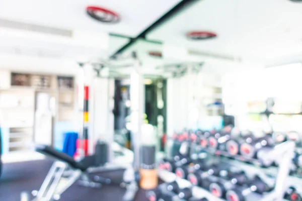 Abstract blur gym room interior with fitness equipment