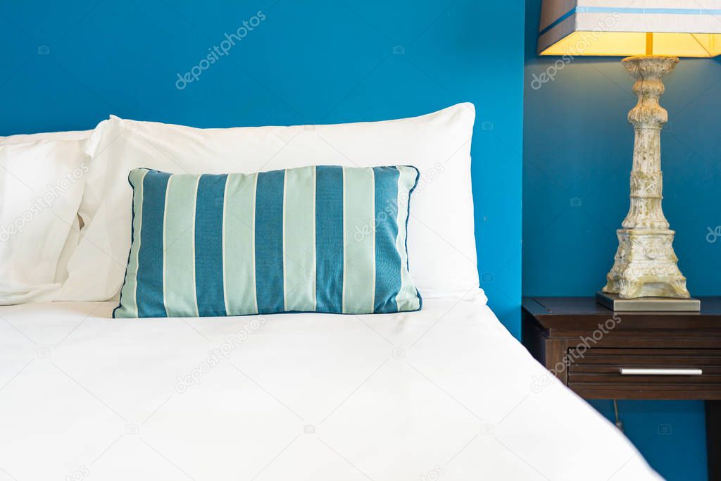 White comfortable pillow on bed decoration interior