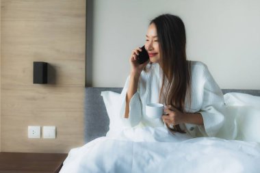 Güzel Asyalı genç kadınların portresi Kahveyle mutlu bir gülümseme ve