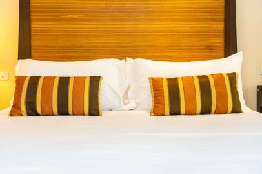 Yatak dekorasyonunda beyaz rahat yastık.