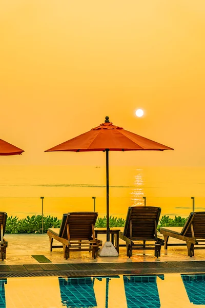 Beautiful sunrise around with umbrella and chair outdoor swimmin — 스톡 사진