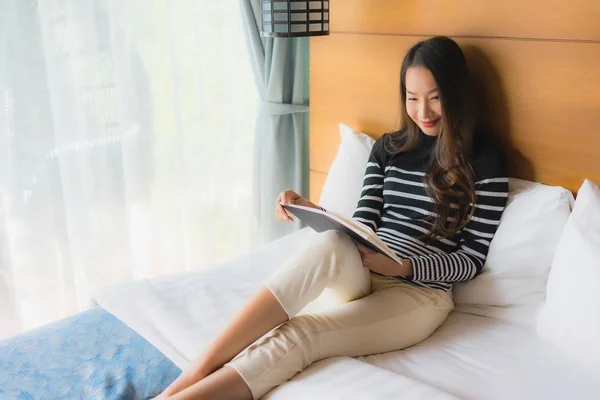 Portrait young asian woman read book in bedroom