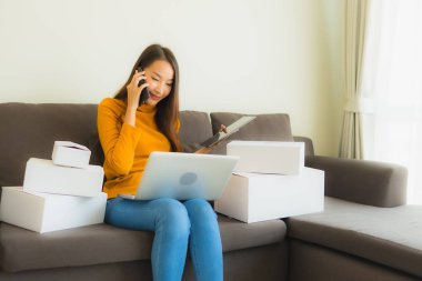 Genç Asyalı kadının portresi P ile çalışmak için dizüstü bilgisayar kullanıyor.