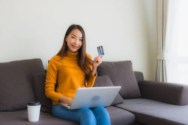 Portrait young asian woman using laptop computer with smart mobi — Stock Photo, Image