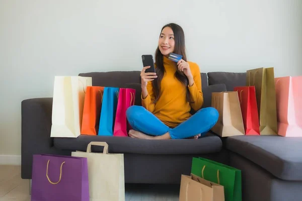 Retrato joven asiática mujer usando portátil ordenador con inteligente mobi — Foto de Stock