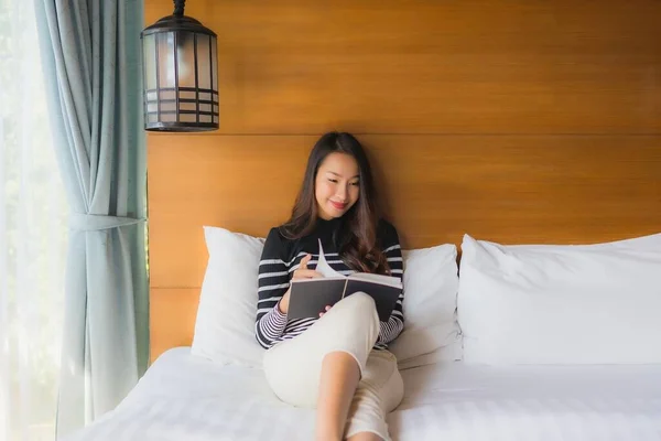 Portrait young asian woman read book in bedroom