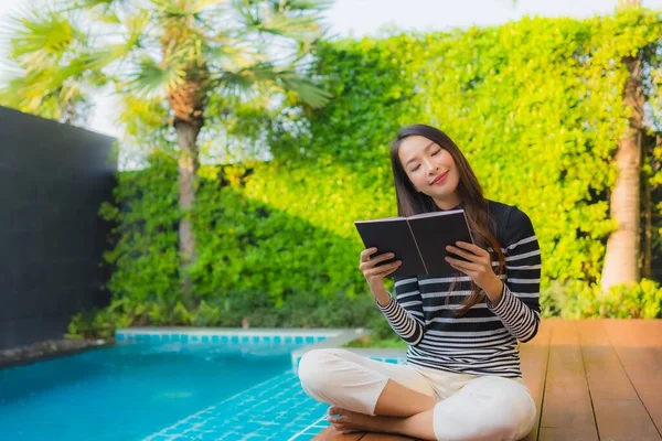 Ritratto giovane donna asiatica leggere libro intorno piscina all'aperto poo — Foto Stock