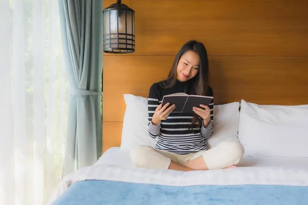 Portrait young asian woman read book in bedroom