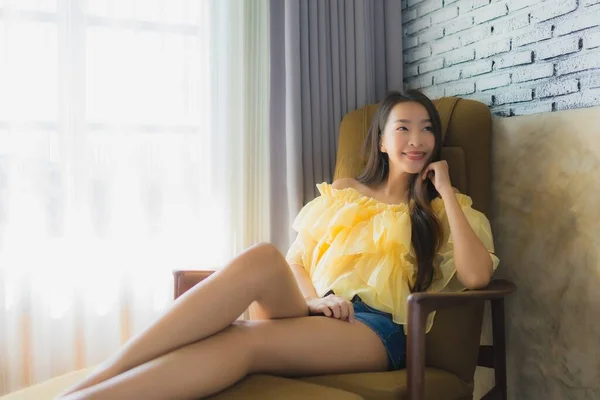 Portrait young asian woman relax happy smile on sofa chair in li — 스톡 사진