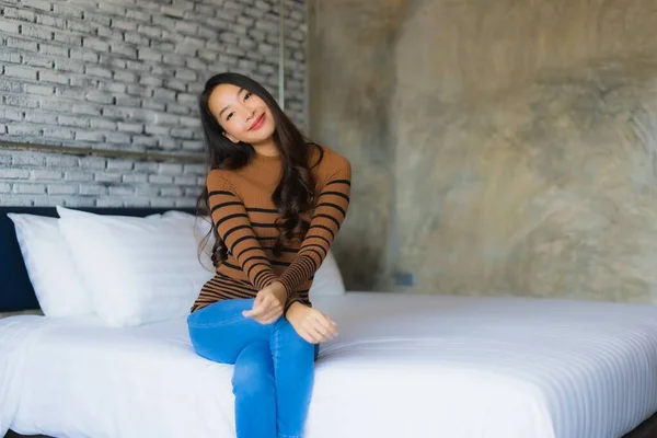 Young asian woman happy smile relax on bed in bedroom — 스톡 사진