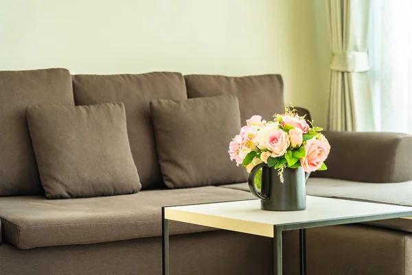 Vase flower on table with pillow and sofa decoration interior — Stock Photo, Image