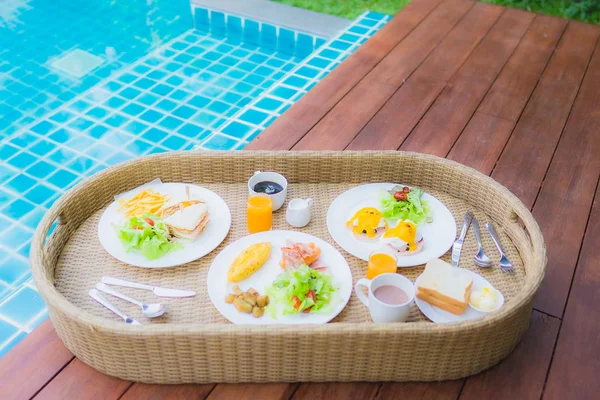 Floating breakfast around outdoor swimming pool — 스톡 사진